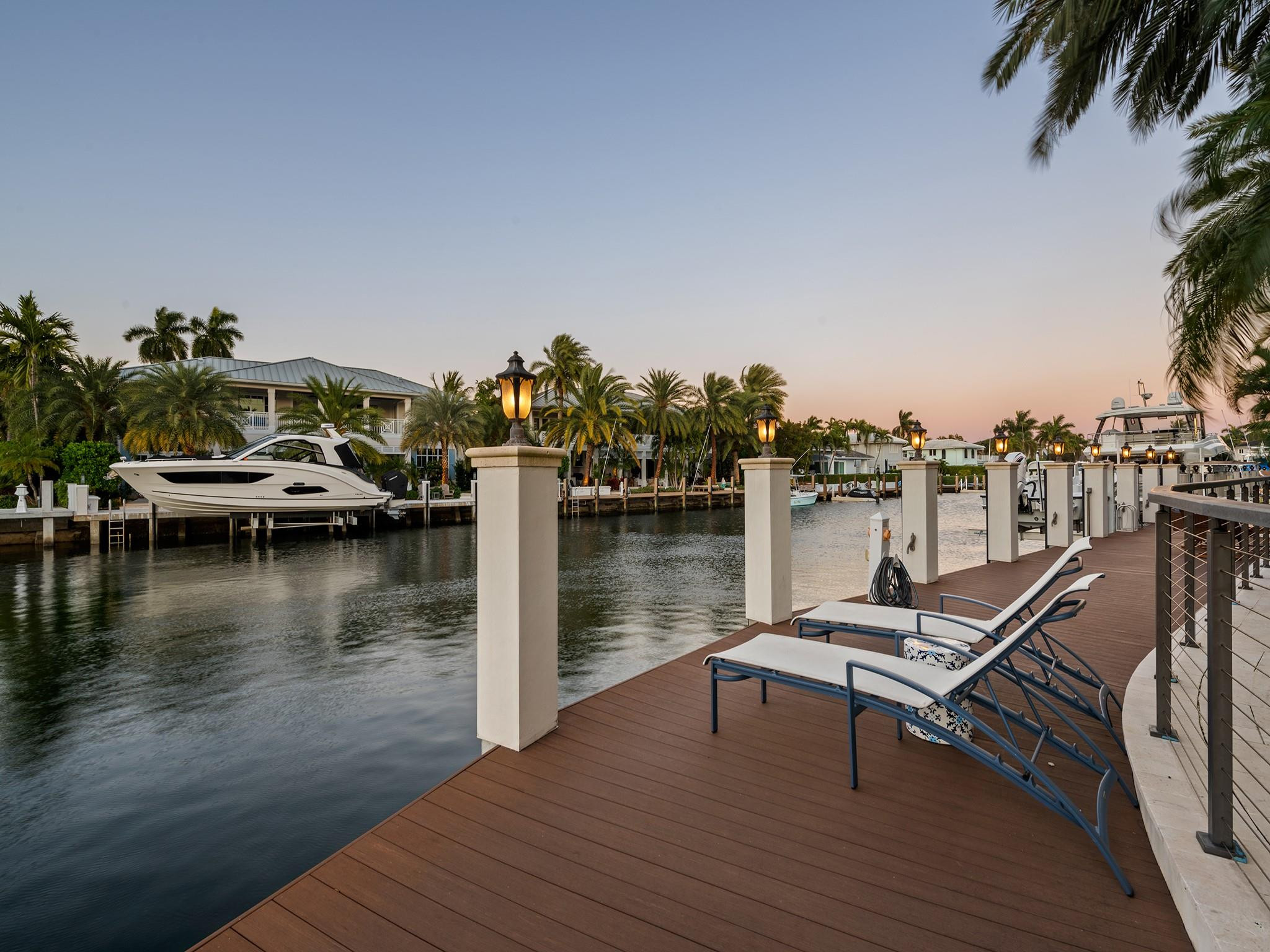 2319 Northeast 28th Street Lighthouse Point, FL 33064 - Photo 56 of 59 a view of a lake with chairs
