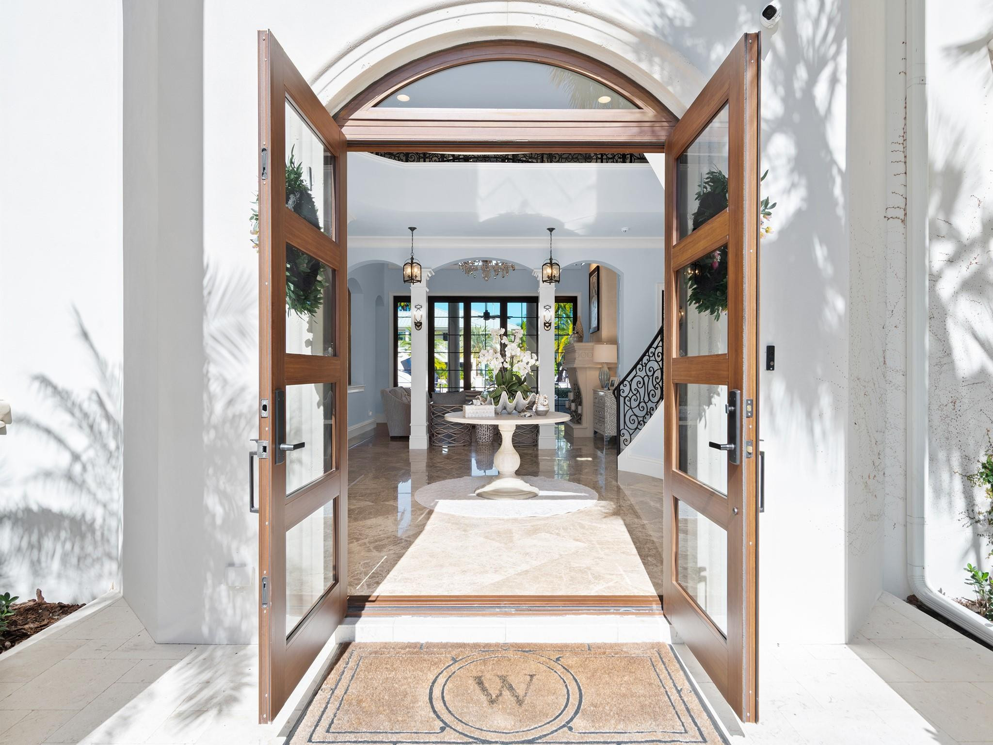 2319 Northeast 28th Street Lighthouse Point, FL 33064 - Photo 6 of 59 a view of a hallway with wooden floor and a large window