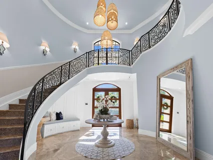 a view of a dining room with furniture and chandelier