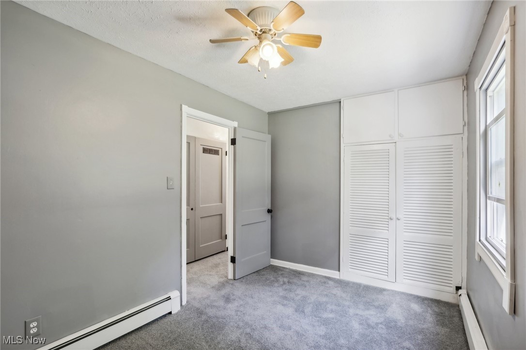 1829 Clyde Road Madison, OH 44057 - Photo 36 of 40 Unfurnished bedroom with a baseboard radiator, a closet, and ceiling fan
