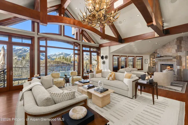 a living room with furniture and a floor to ceiling window