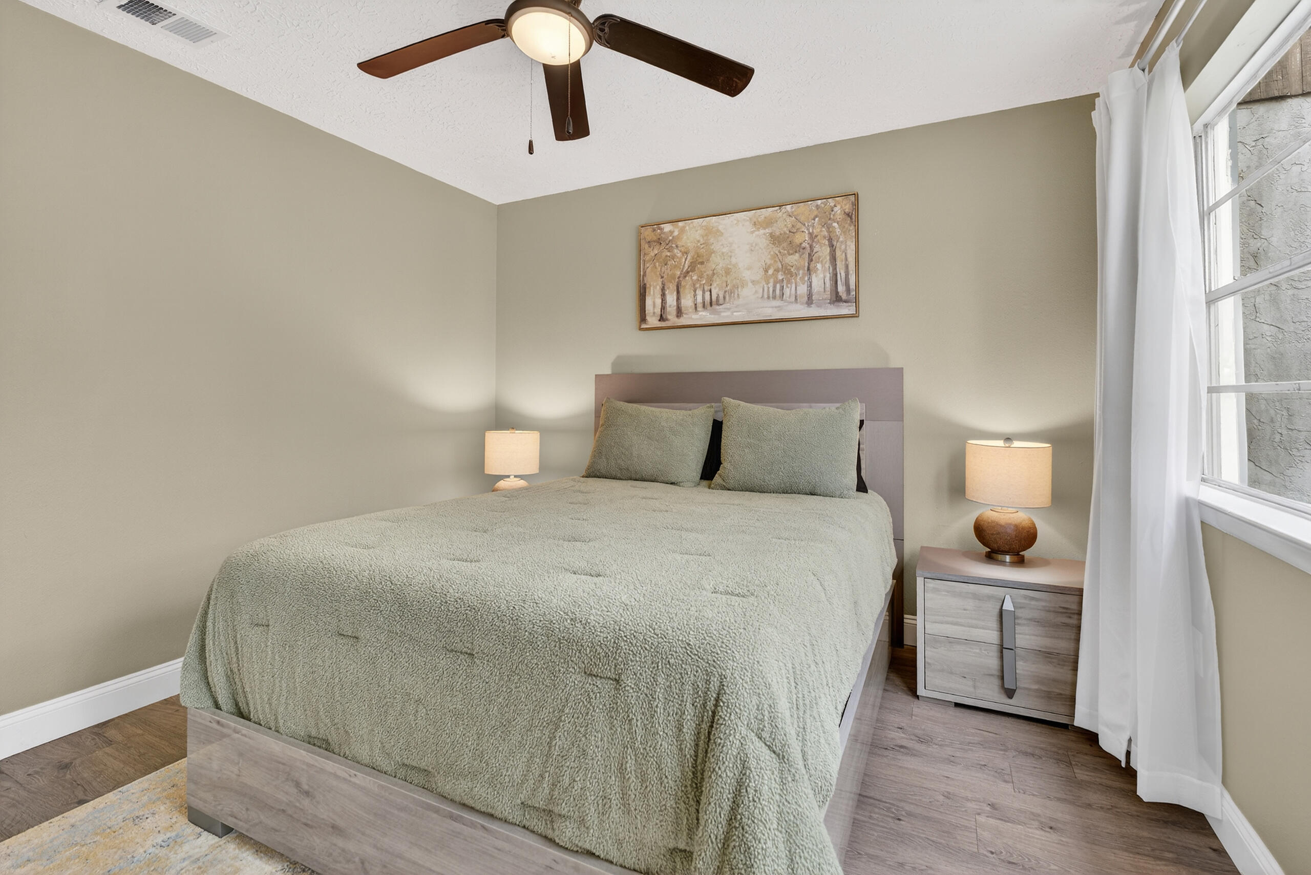 35 10th Street, Unit D Shalimar, FL 32579 - Photo 27 of 33 a bedroom with a bed and a painting on the wall