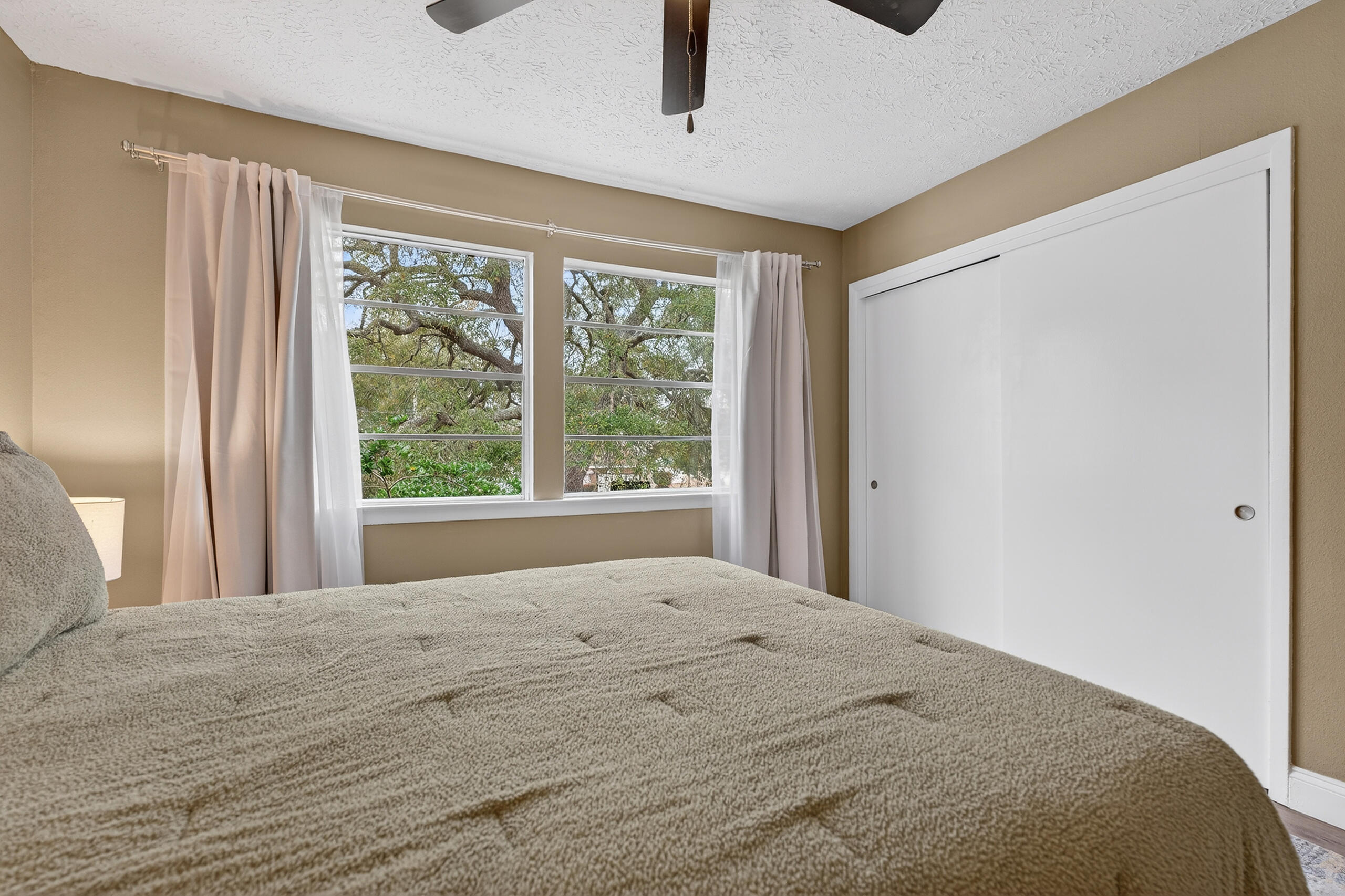35 10th Street, Unit D Shalimar, FL 32579 - Photo 28 of 33 a bedroom with a large bed and a large window