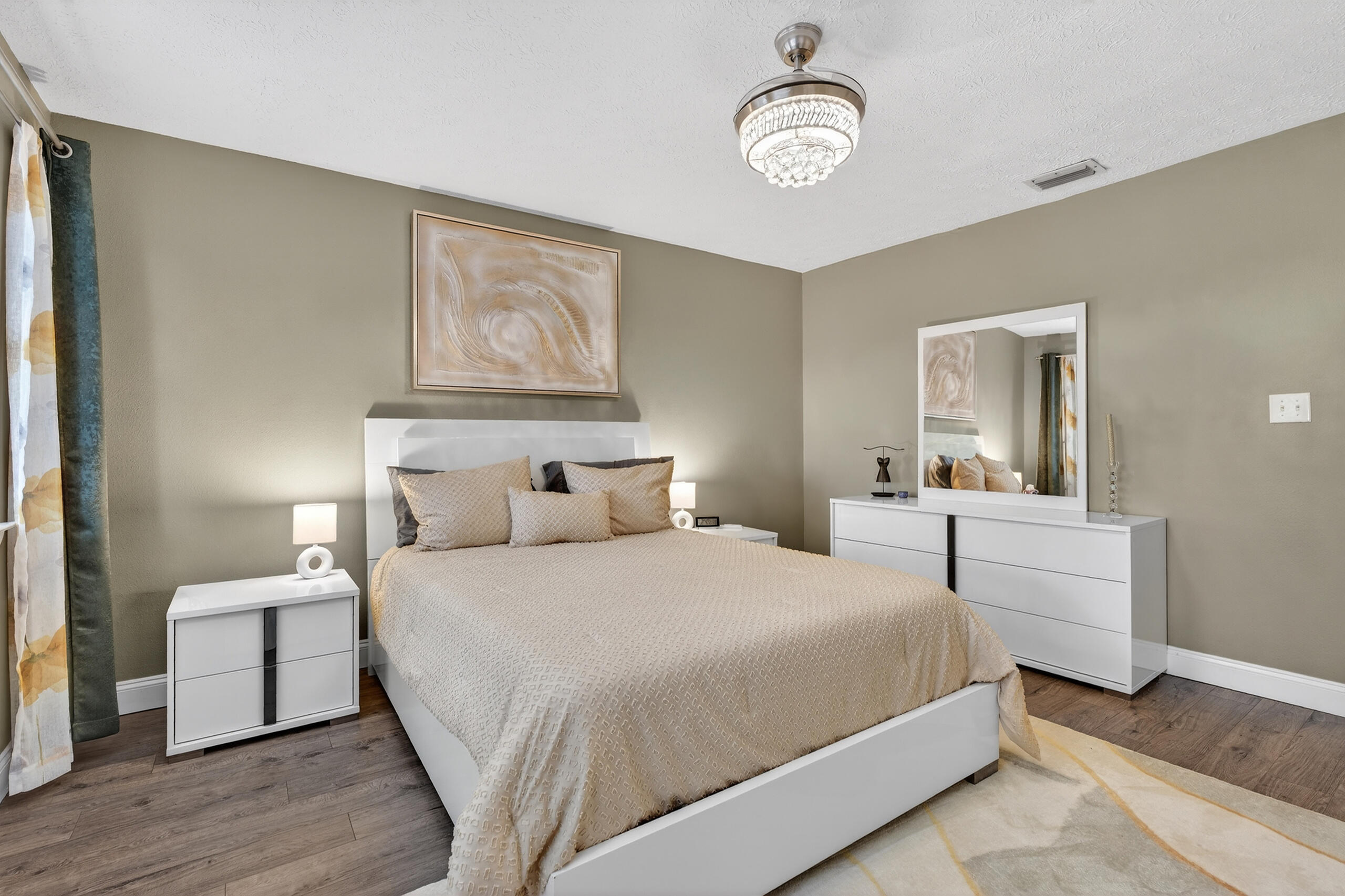 35 10th Street, Unit D Shalimar, FL 32579 - Photo 31 of 33 a bedroom with a large bed and a chandelier