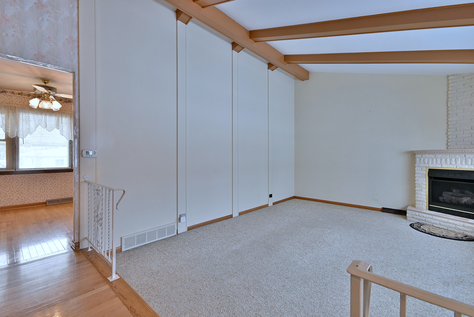 231 North Flora Parkway Addison, IL 60101 - Photo 5 of 39 a view of an empty room with wooden floor and a fireplace
