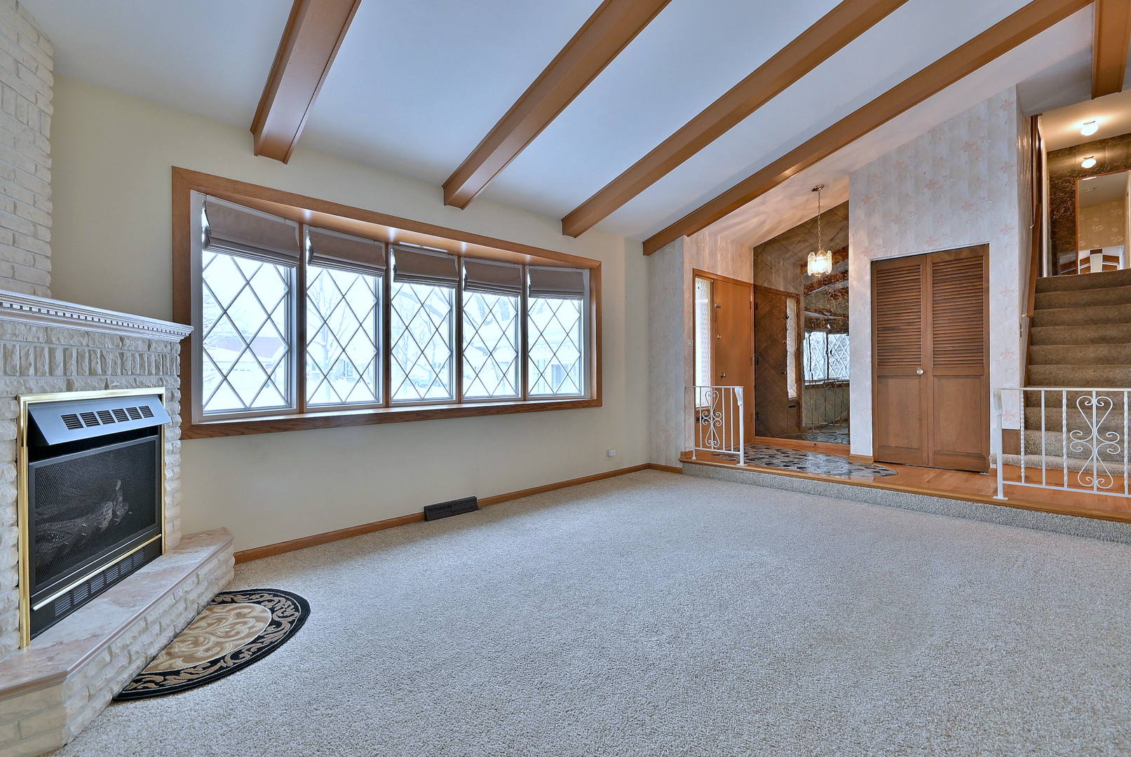231 North Flora Parkway Addison, IL 60101 - Photo 6 of 39 a view of an empty room with a fireplace and a window