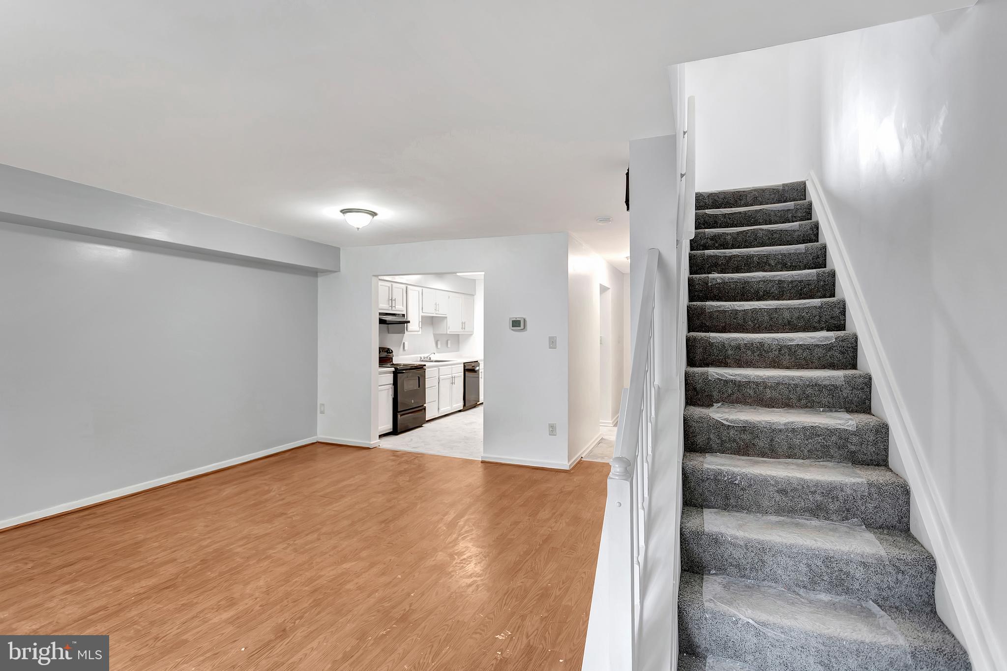 2347 McCulloh Street Baltimore, MD 21217 - Photo 11 of 28 a view of an empty room with wooden floor and stairs