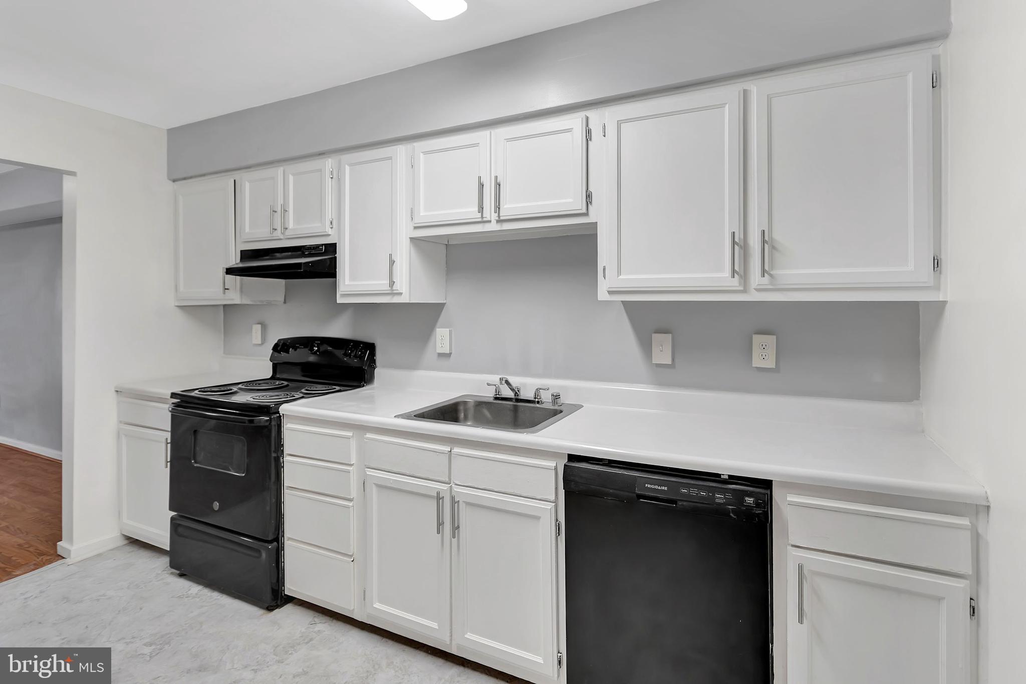 2347 McCulloh Street Baltimore, MD 21217 - Photo 6 of 28 a kitchen with white cabinets and a stove
