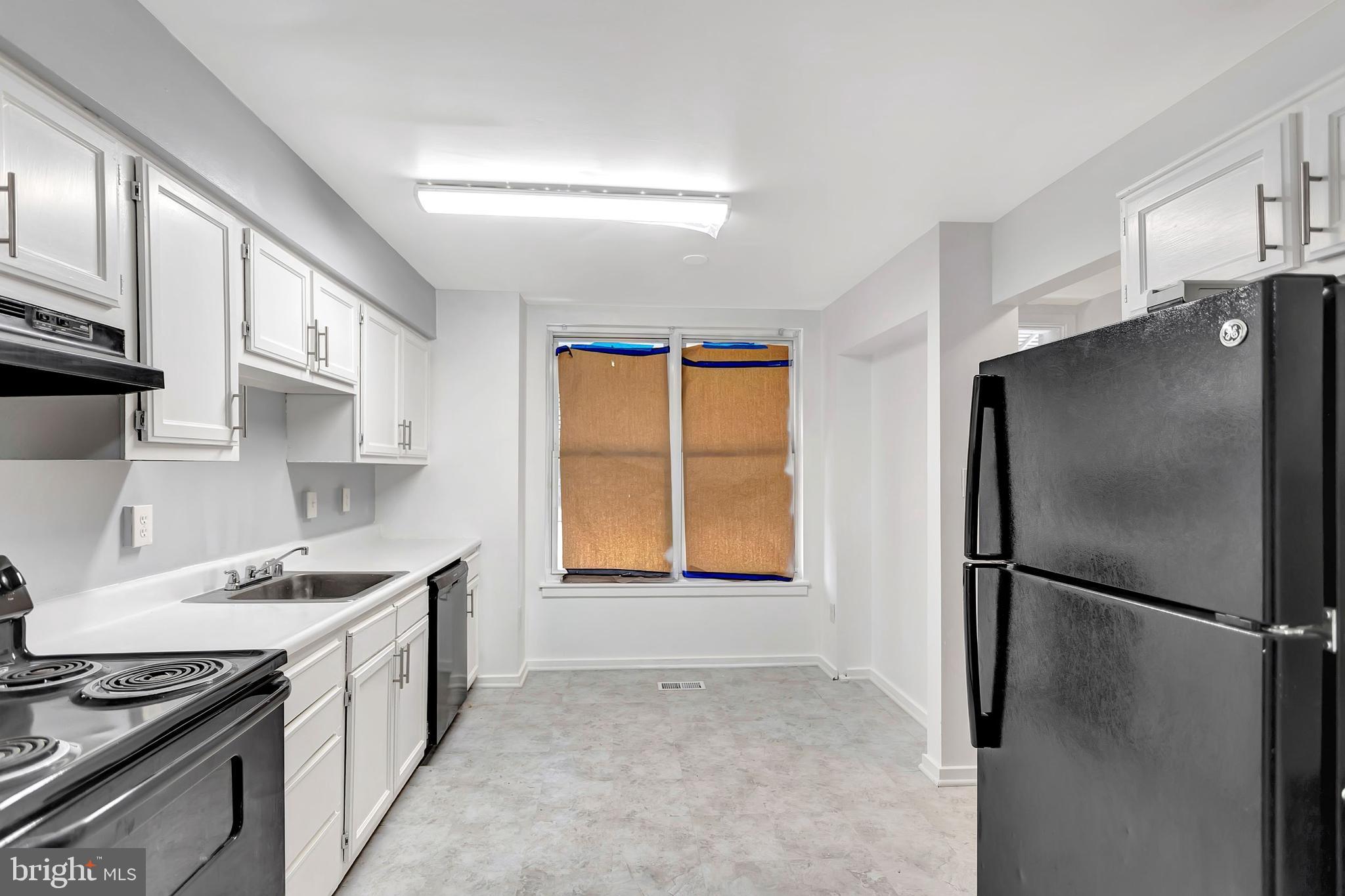 2347 McCulloh Street Baltimore, MD 21217 - Photo 8 of 28 a kitchen with stainless steel appliances granite countertop a refrigerator a sink and a stove