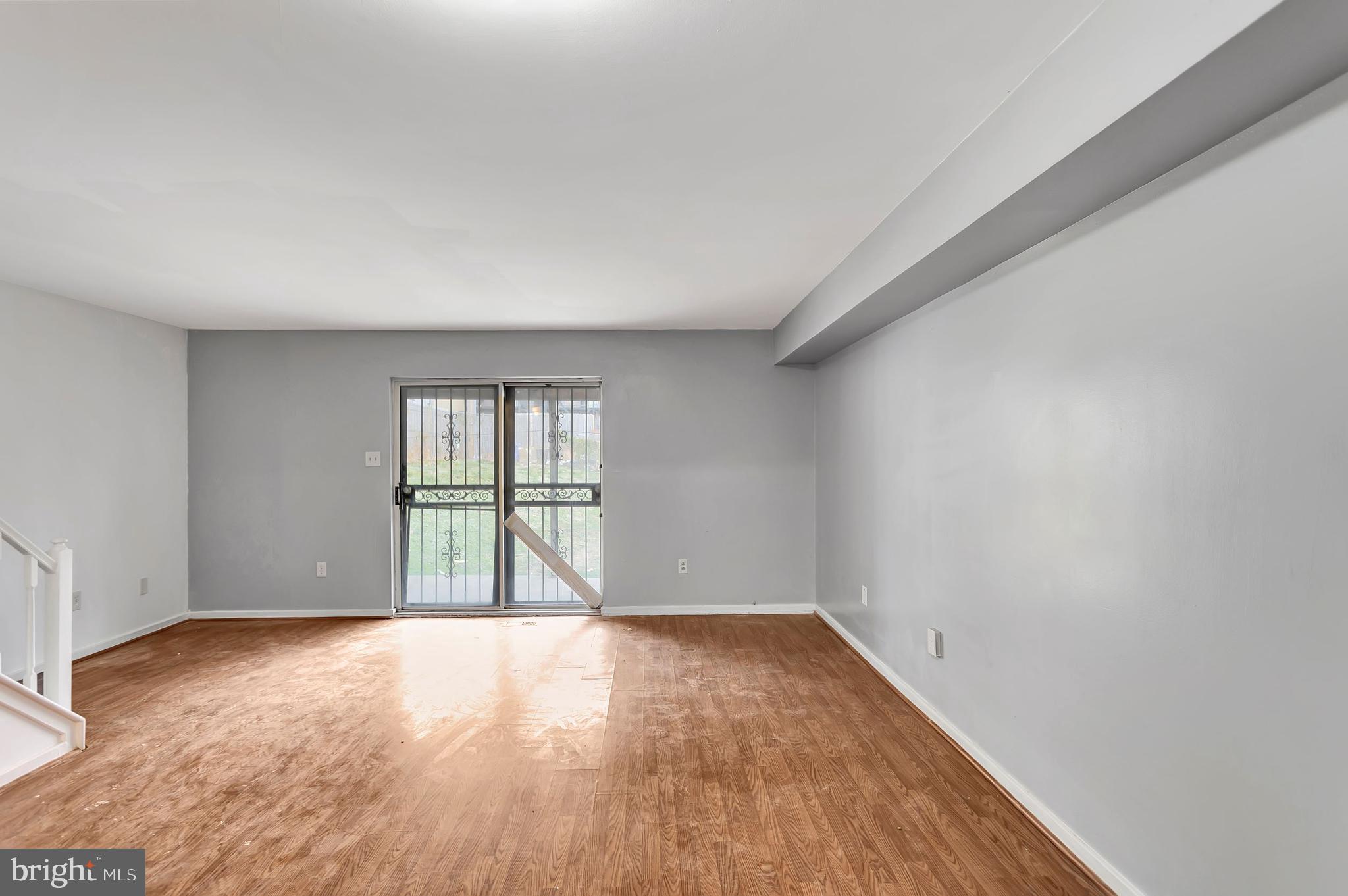 2347 McCulloh Street Baltimore, MD 21217 - Photo 9 of 28 an empty room with wooden floor and windows