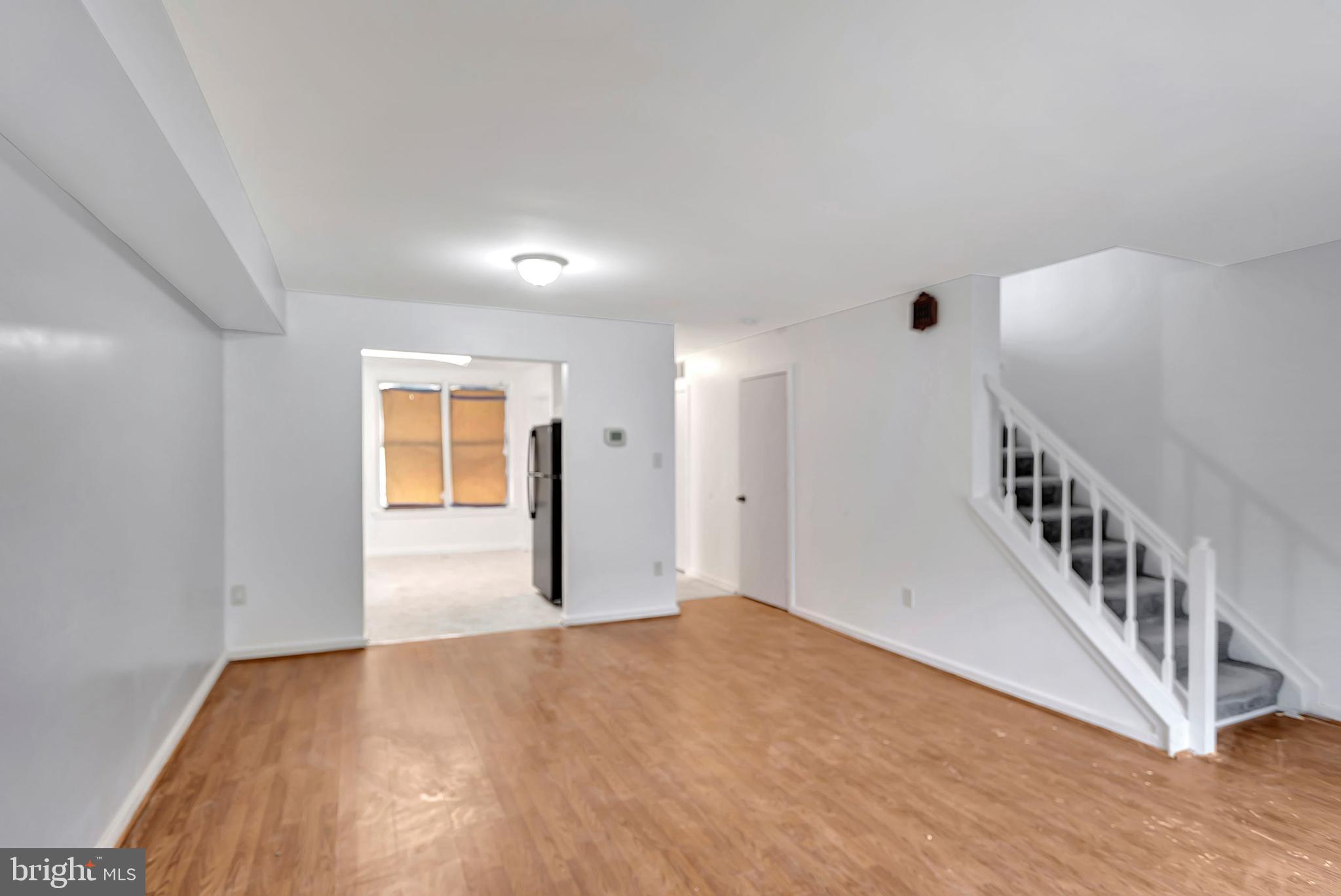 2347 McCulloh Street Baltimore, MD 21217 - Photo 10 of 28 a view of an empty room with wooden floor and windows