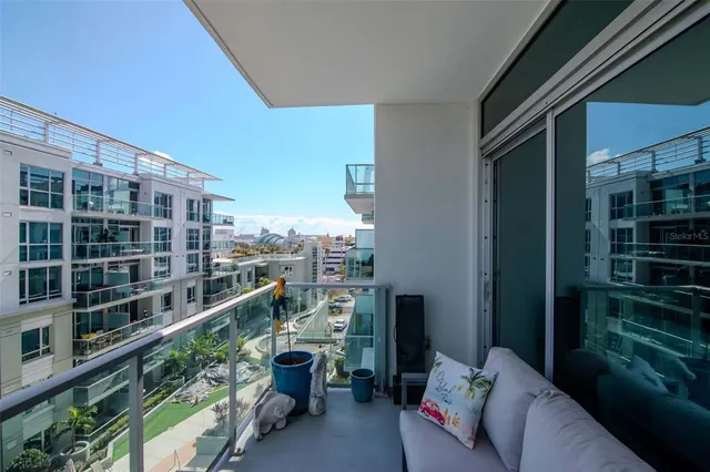 a picture of table and chairs in a balcony