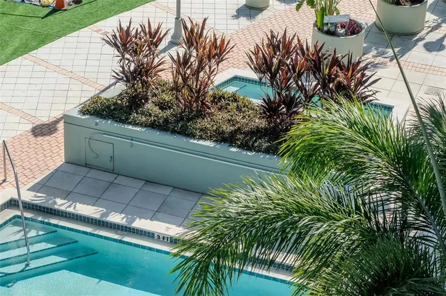 a view of a patio with table and chairs and potted plants