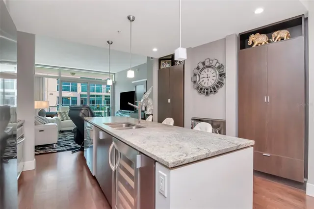 a kitchen with granite countertop stainless steel appliances a sink stove and cabinets