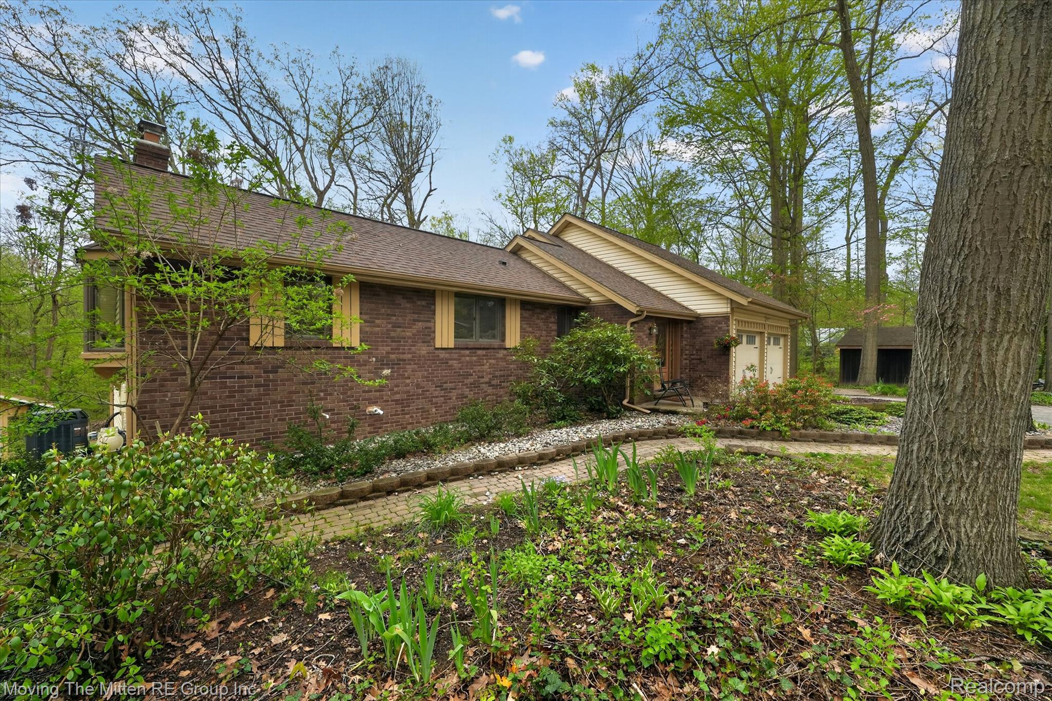 41825 Fret Road Belleville, MI 48111 - Photo 55 of 67 View of property exterior with a chimney, brick siding, and an attached garage