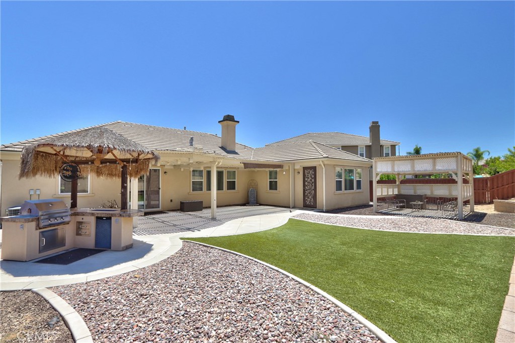 28483 Nautical Point Circle Menifee, CA 92585 - Photo 34 of 44 a front view of a house with a garden and yard