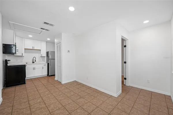 a kitchen with a sink a stove cabinets and a refrigerator