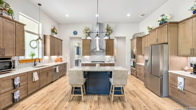 a large kitchen with a table and chairs