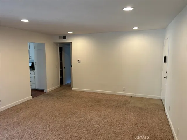 an empty room with closet and a projector screen