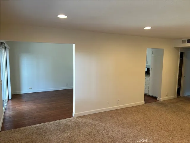 an empty room with wooden floor