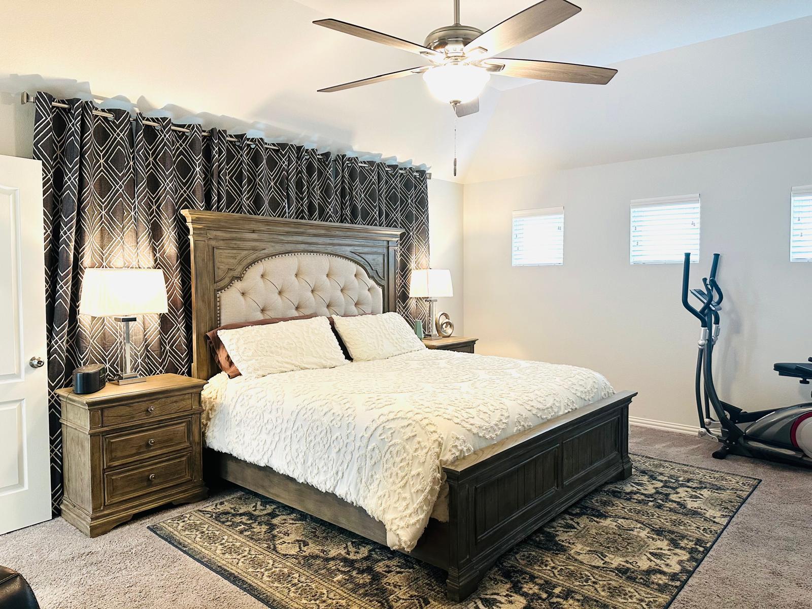 862 Leadtree Loop Buda, TX 78610 - Photo 23 of 40 a bedroom with a bed and wooden floor