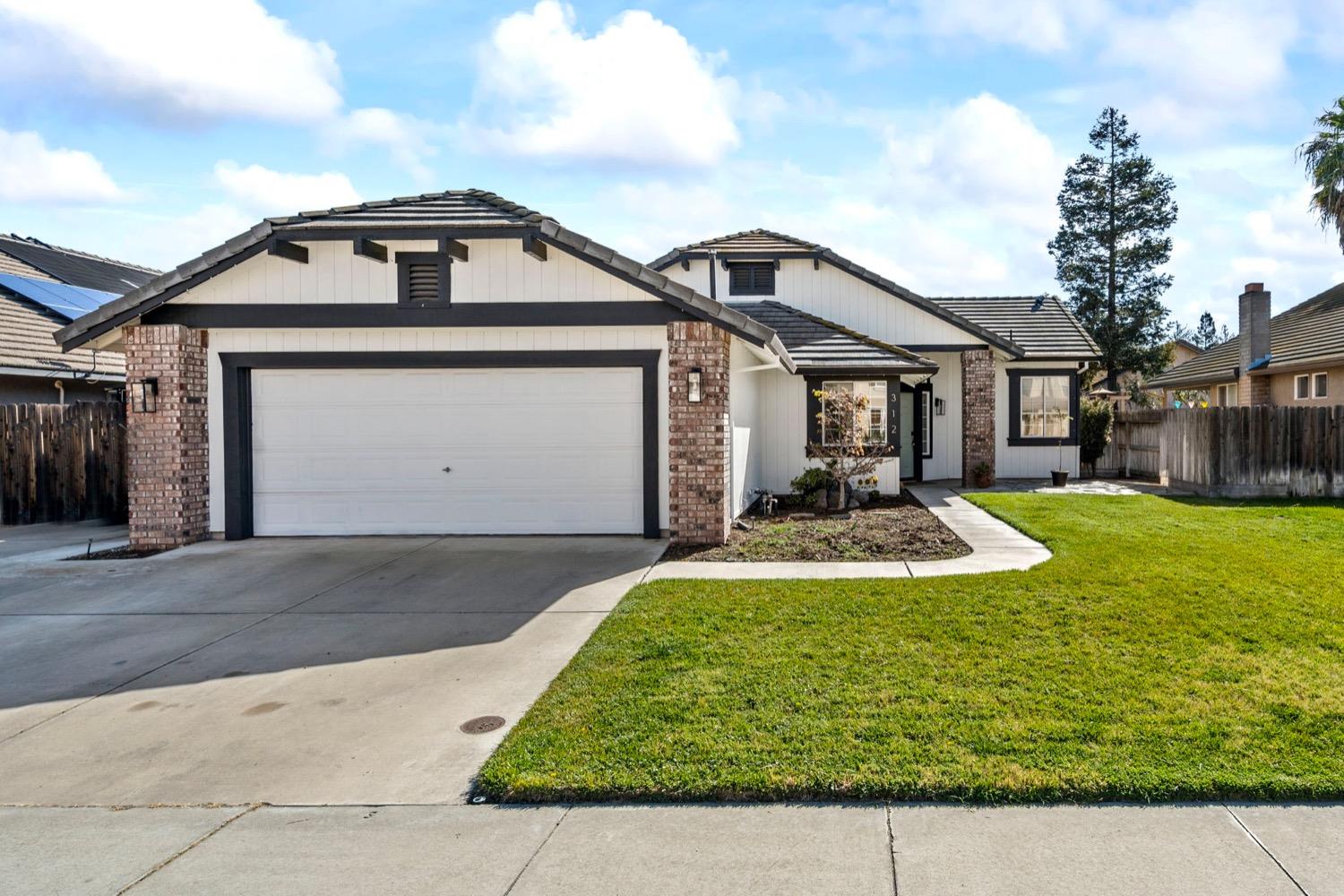 312 Ruess Road Ripon, CA 95366 - Photo 1 of 1 a front view of a house with a yard garage and outdoor seating