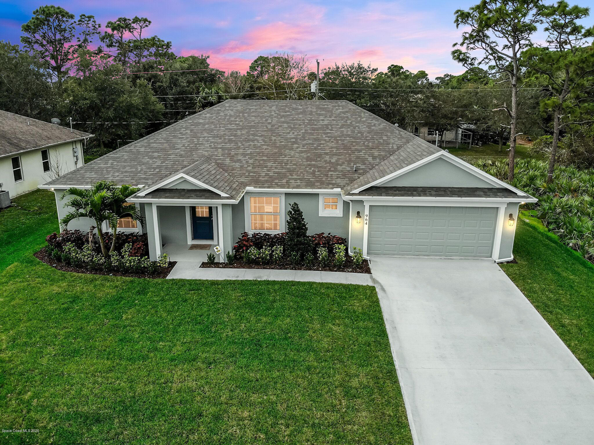 261 Abalone Road Northwest Palm Bay, FL 32907 - Photo 1 of 18 a front view of a house with a garden