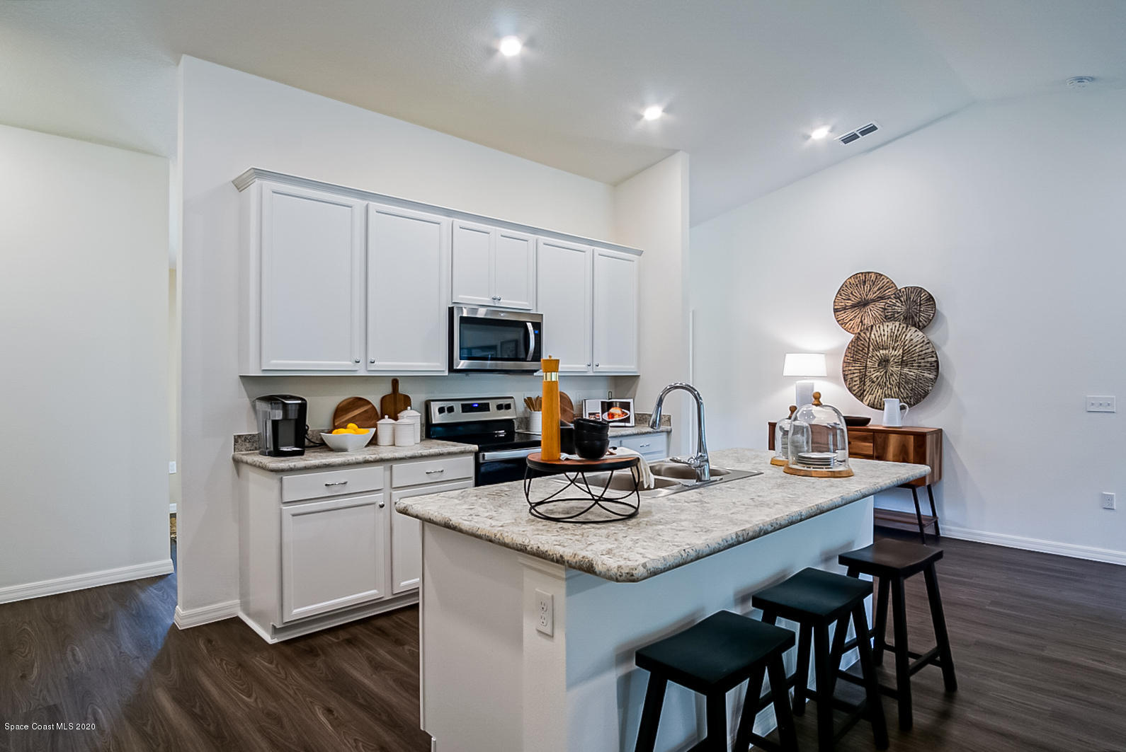 261 Abalone Road Northwest Palm Bay, FL 32907 - Photo 11 of 18 a kitchen with granite countertop a sink appliances and cabinets