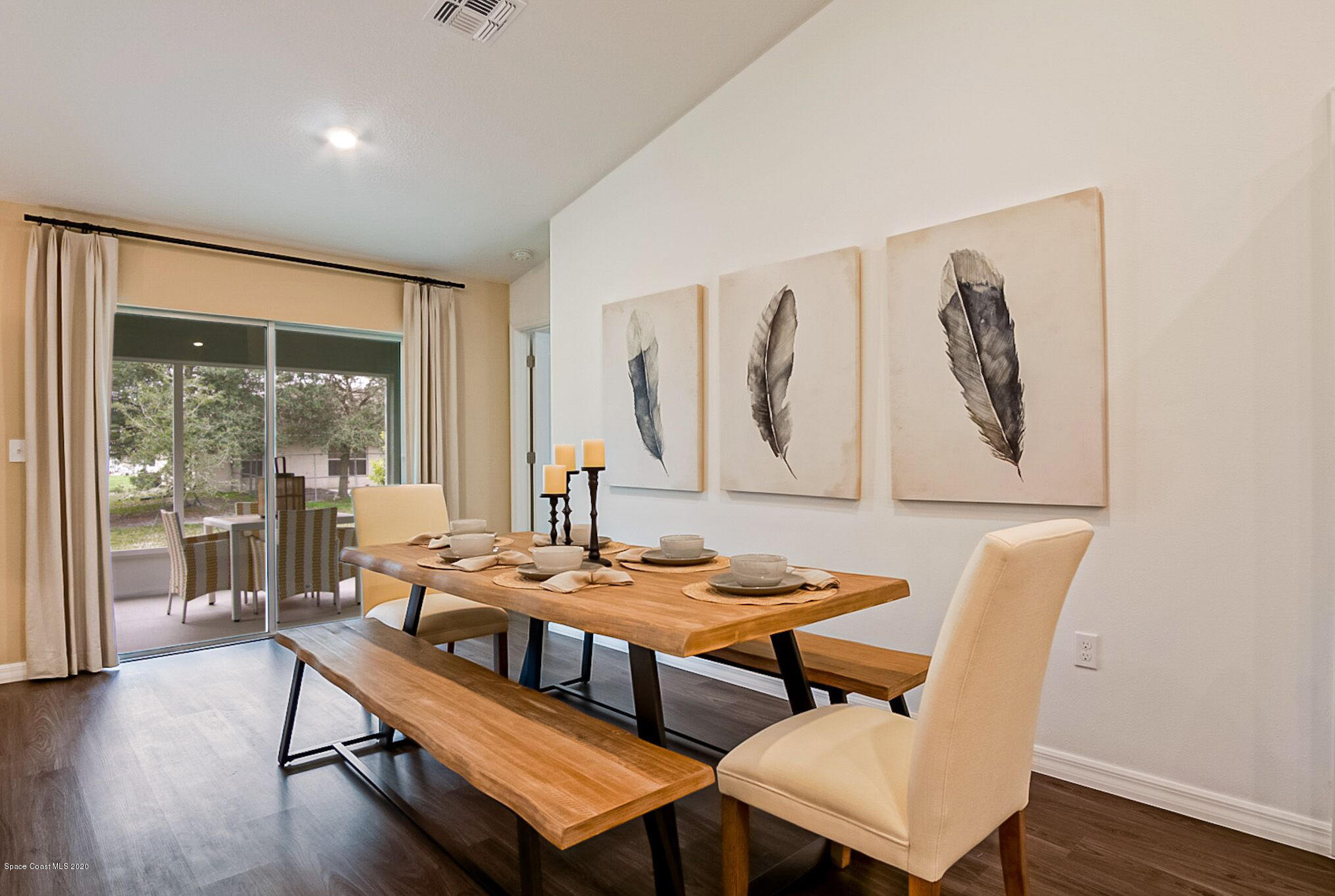 261 Abalone Road Northwest Palm Bay, FL 32907 - Photo 3 of 18 a dining room with furniture and wooden floor