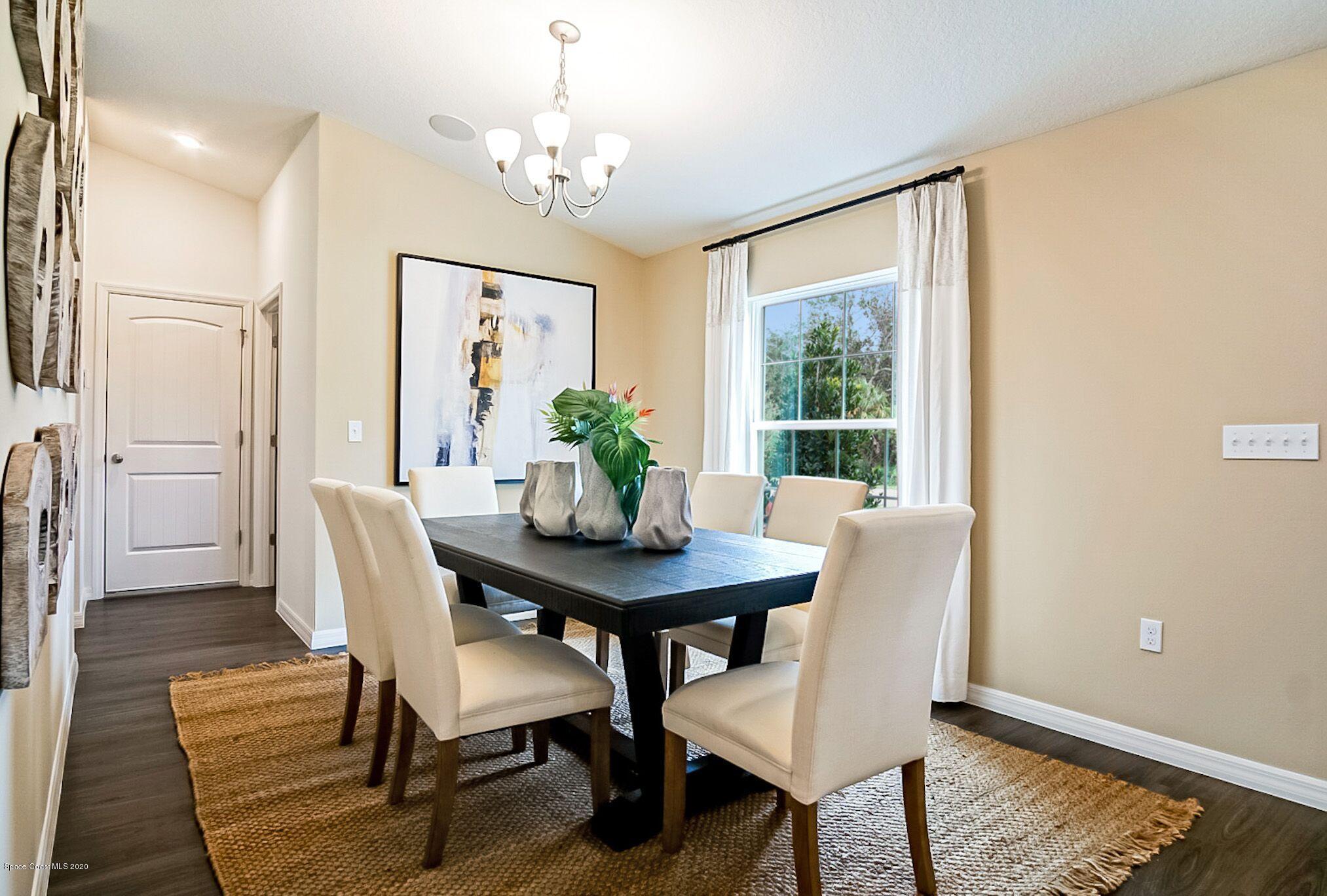 261 Abalone Road Northwest Palm Bay, FL 32907 - Photo 6 of 18 a view of a dining room with furniture window and wooden floor
