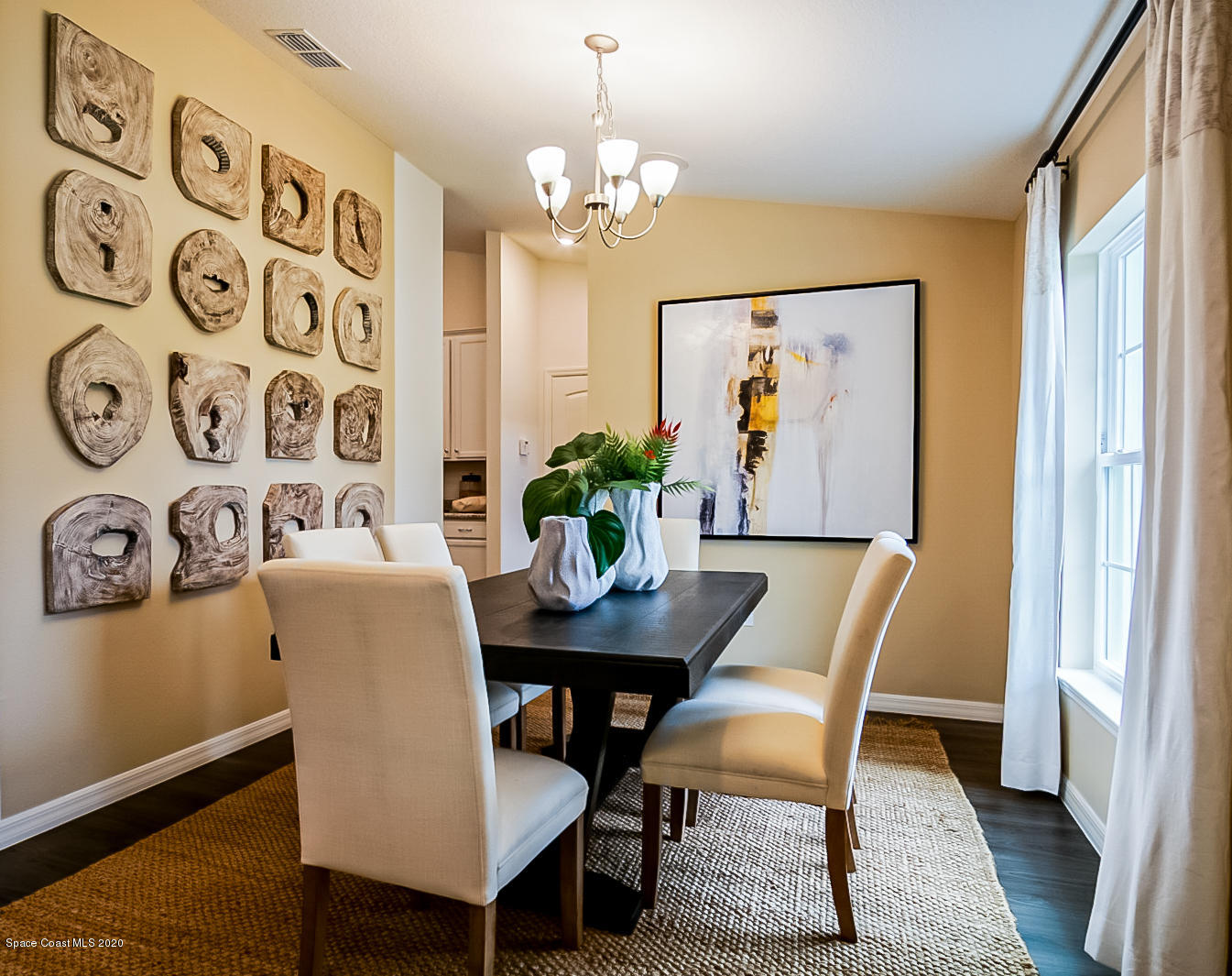 261 Abalone Road Northwest Palm Bay, FL 32907 - Photo 9 of 18 a view of a dining room with furniture and a chandelier
