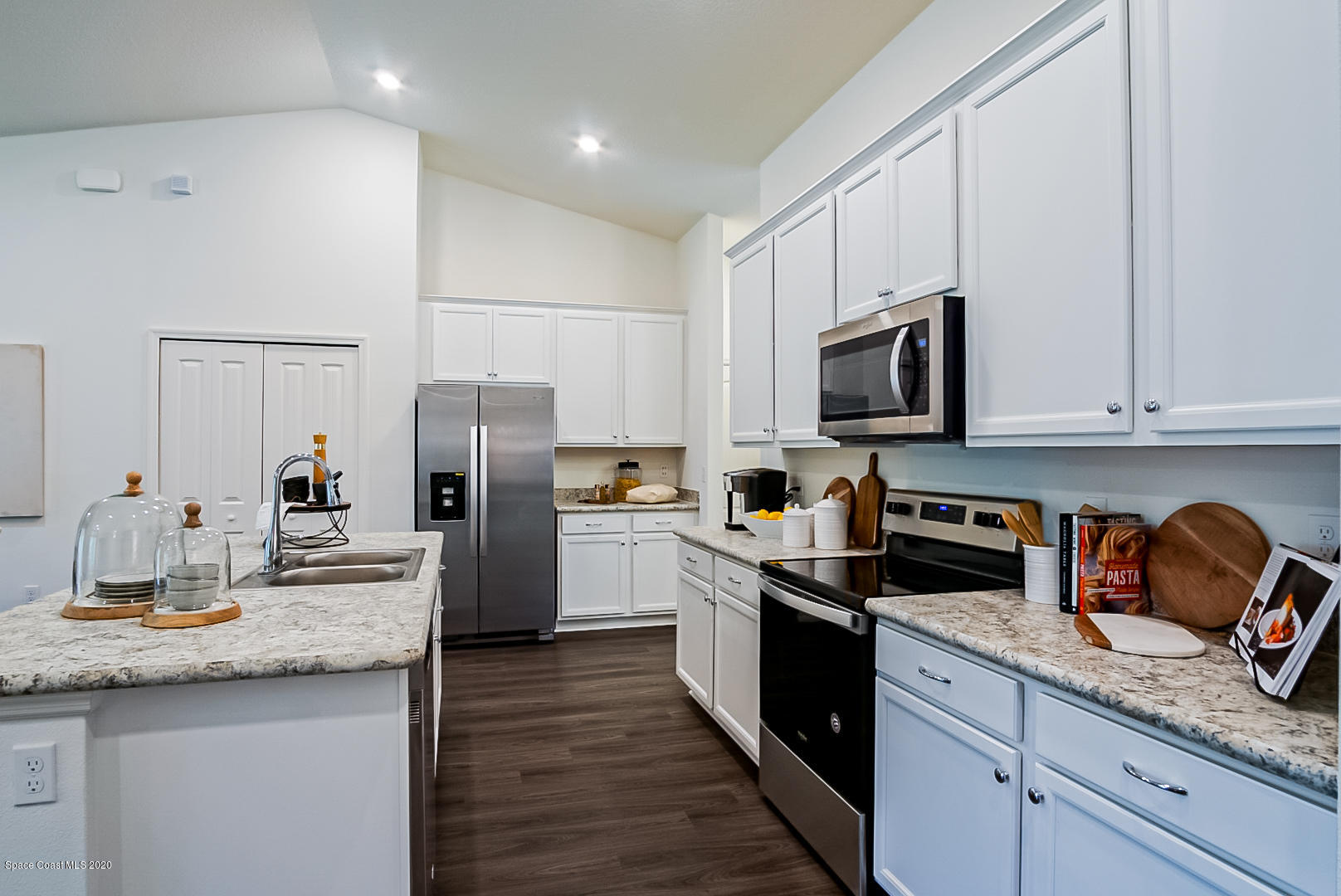 261 Abalone Road Northwest Palm Bay, FL 32907 - Photo 10 of 18 a kitchen with granite countertop stainless steel appliances and wooden cabinets