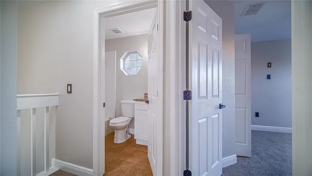 a bathroom with a granite countertop toilet and a shower