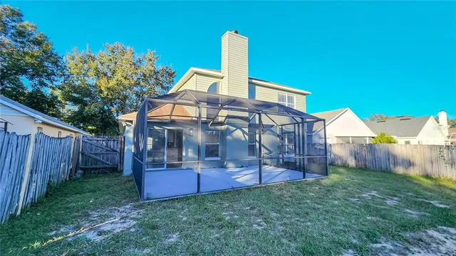 an aerial view of a house with garden space and street view