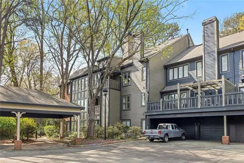a view of a brick building next to a yard