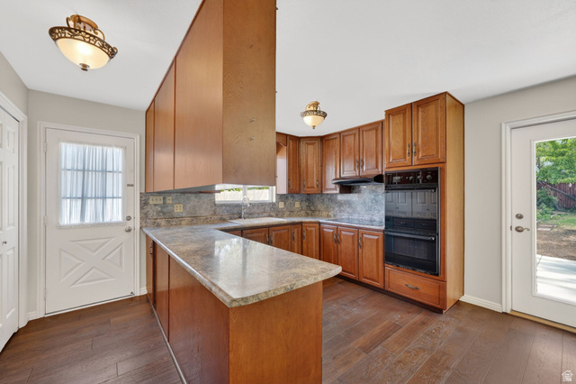 3120 North Apache Way Provo, UT 84604 - Photo 25 of 58 Kitchen featuring wood-finish flooring, wood cabinetry, stone-look countertops, and a built-in double oven
