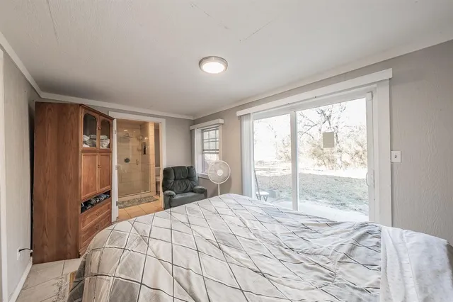 a bedroom with a large bed and large window