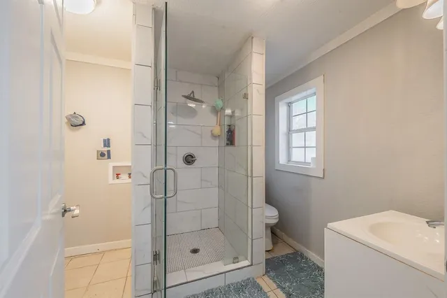 a bathroom with a shower a toilet and sink