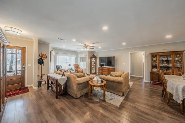 a living room with furniture and a wooden floor