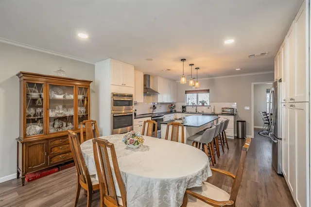 a view of a dining room with furniture and wooden floor