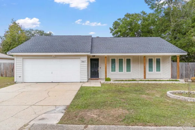 a front view of a house with a garden and yard