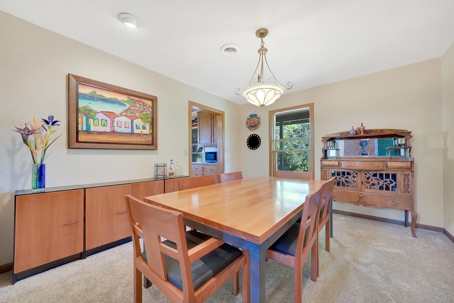 16915 Red Mule Road Fiddletown, CA 95629 - Photo 18 of 66 a view of a dining room with furniture and a chandelier