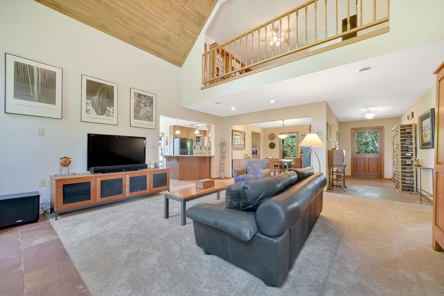 16915 Red Mule Road Fiddletown, CA 95629 - Photo 19 of 66 a living room with furniture and a flat screen tv