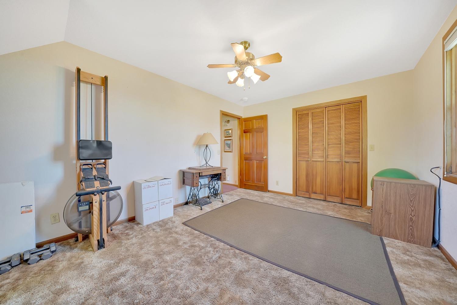 16915 Red Mule Road Fiddletown, CA 95629 - Photo 30 of 66 a view of a livingroom with a lounge chair and a large window