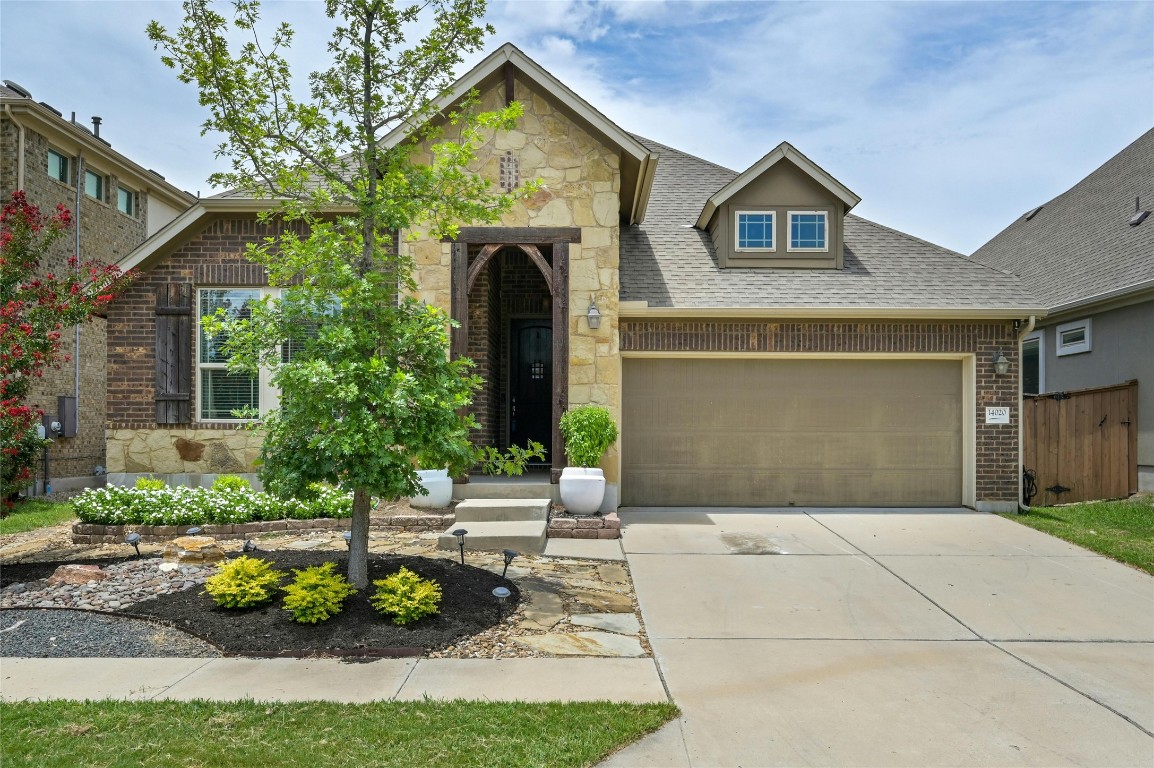 14020 Tyburn Trail Austin, TX 78717 - Photo 1 of 1 a front view of a house with garden