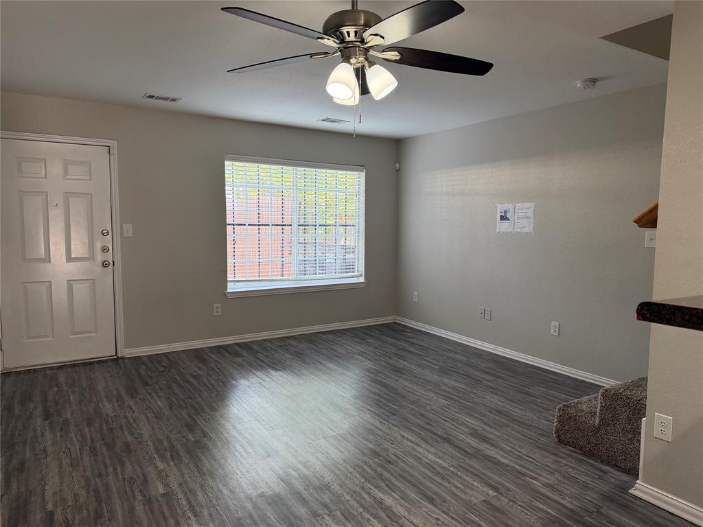 4005 Preferred Place Dallas, TX 75237 - Photo 12 of 31 a view of an empty room with wooden floor and a window