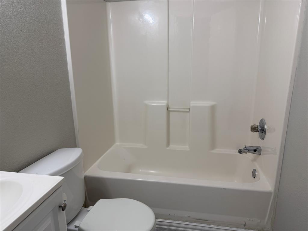 4005 Preferred Place Dallas, TX 75237 - Photo 17 of 31 a white bath tub sitting next to a white toilet