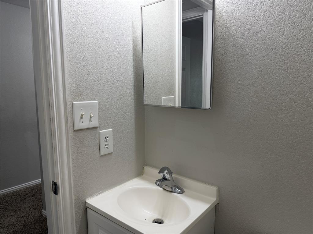 4005 Preferred Place Dallas, TX 75237 - Photo 18 of 31 a bathroom with a sink and a mirror