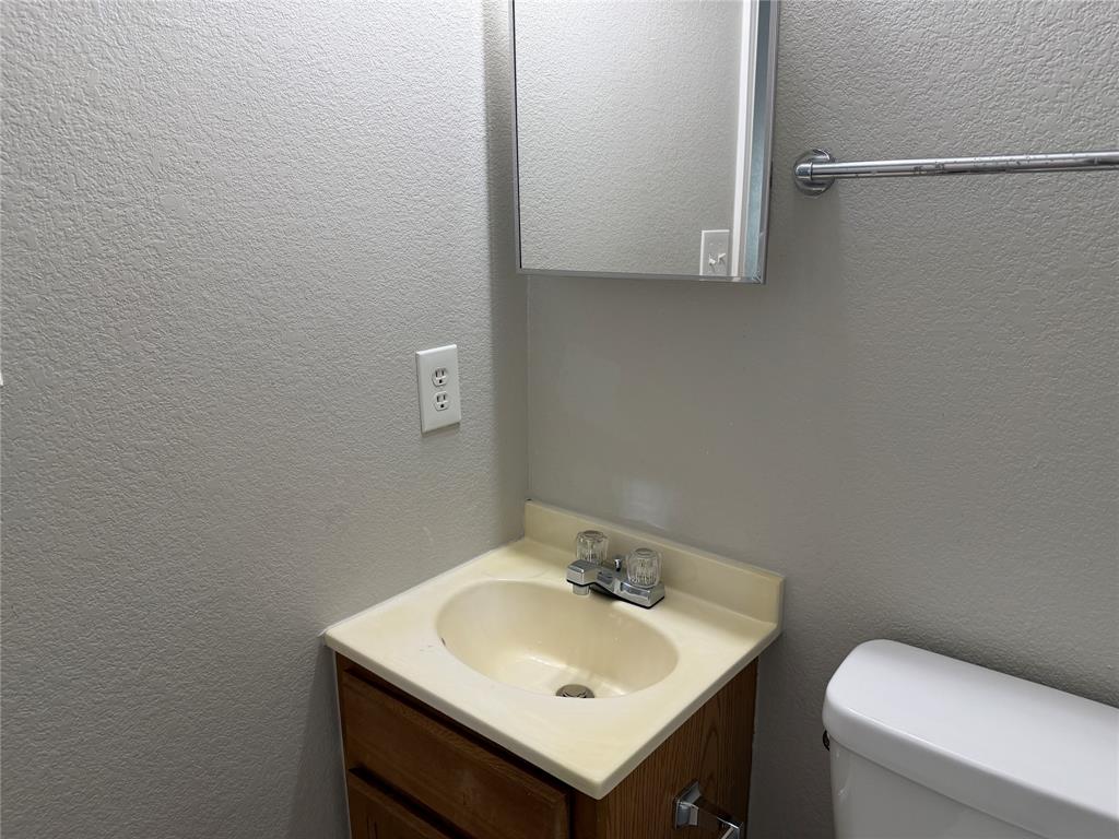 4005 Preferred Place Dallas, TX 75237 - Photo 21 of 31 a bathroom with a sink and a toilet