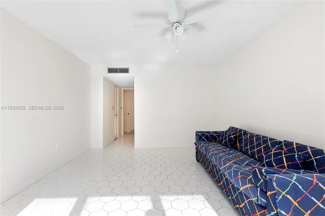 a bedroom with a large bed and a flat tv screen on dresser